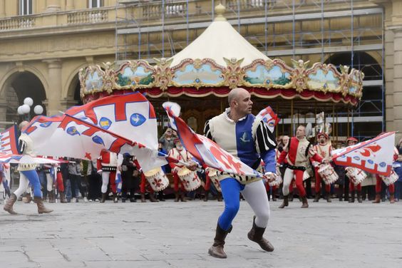 Flag Twirler In Front Of Carousel At Explosion Of The Cart, Scoppio Del Carro In Tuscany, Florence, Italy